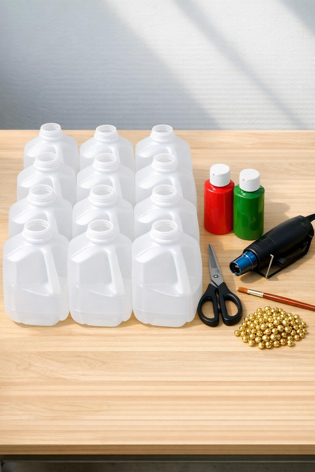 Milk jugs and craft supplies laid out for the project