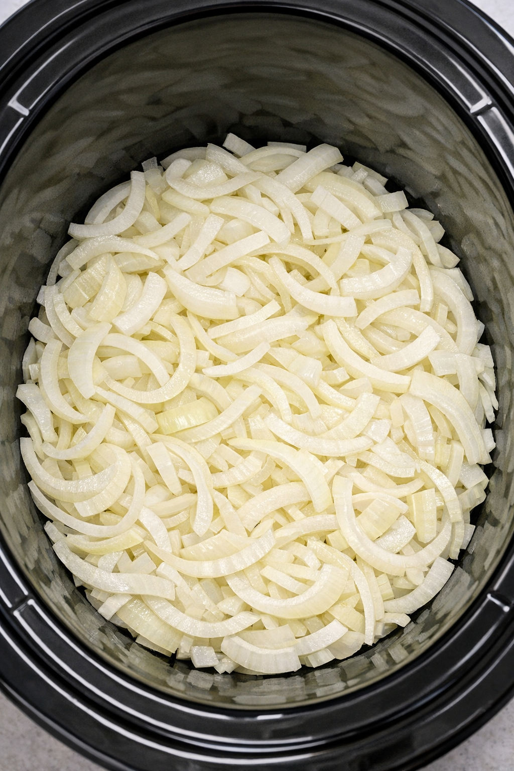 Sliced onions layered in slow cooker