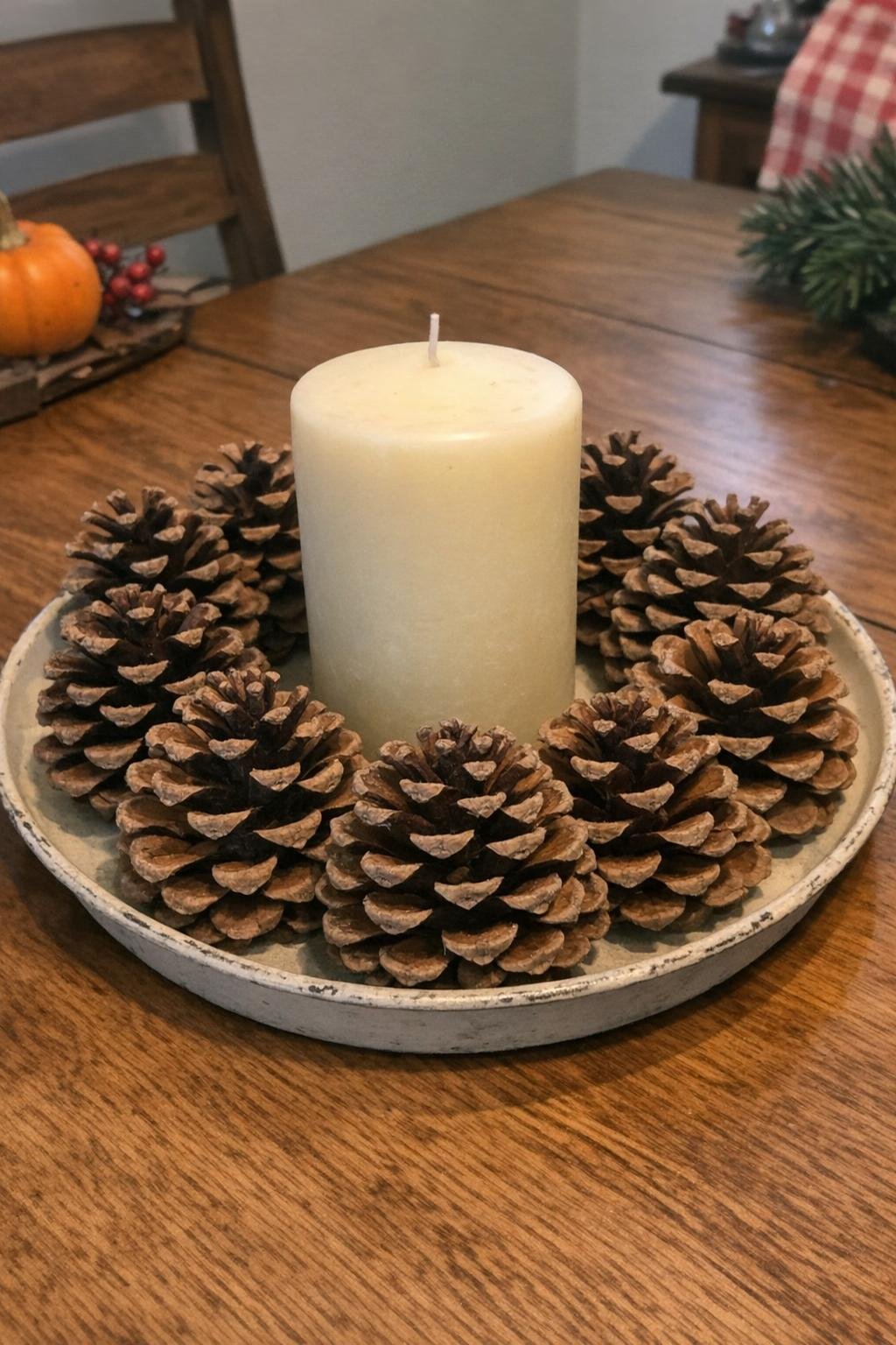 Pine cone candle ring around a pillar candle