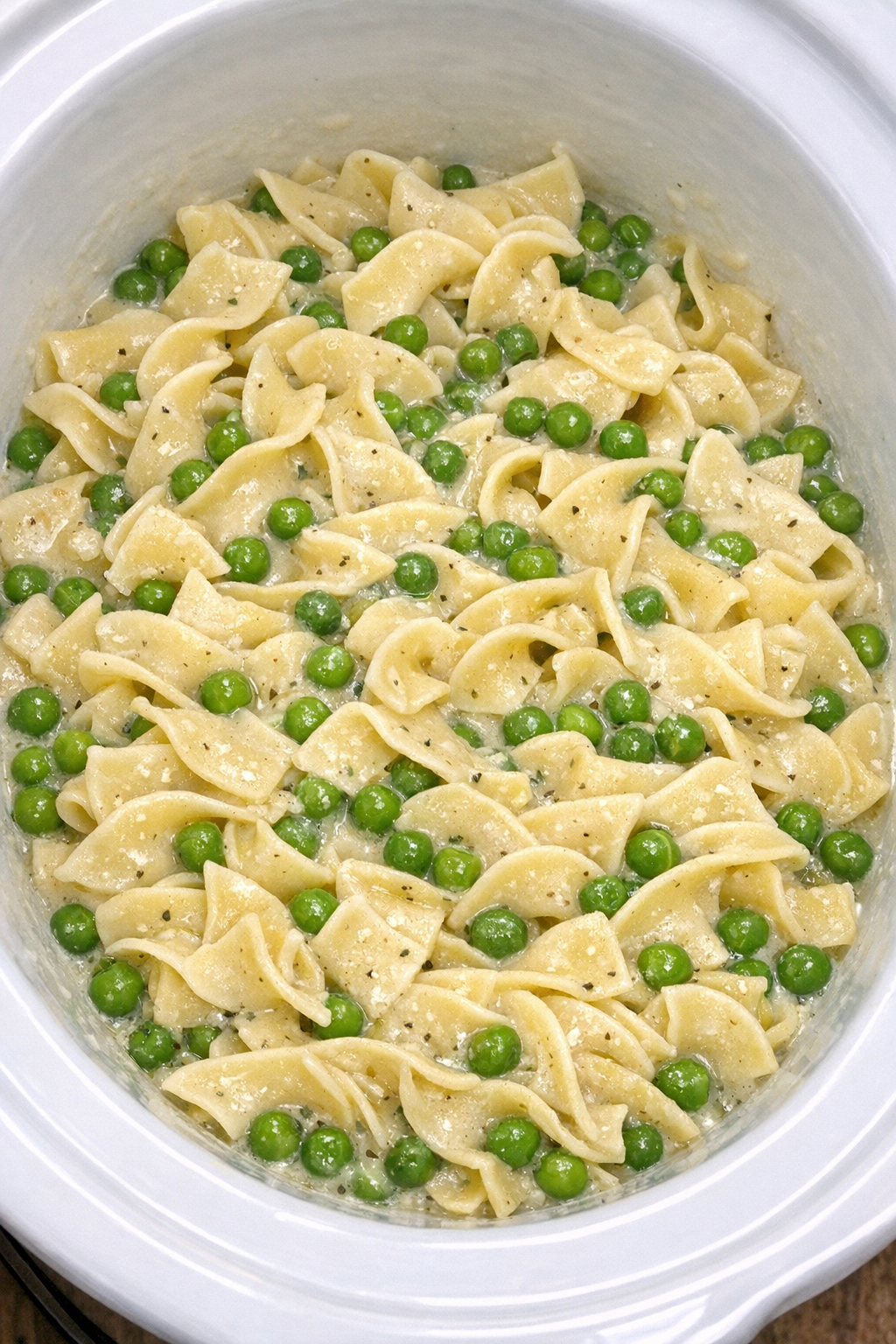 Slow cooker Amish pea noodle pot in a white slow cooker