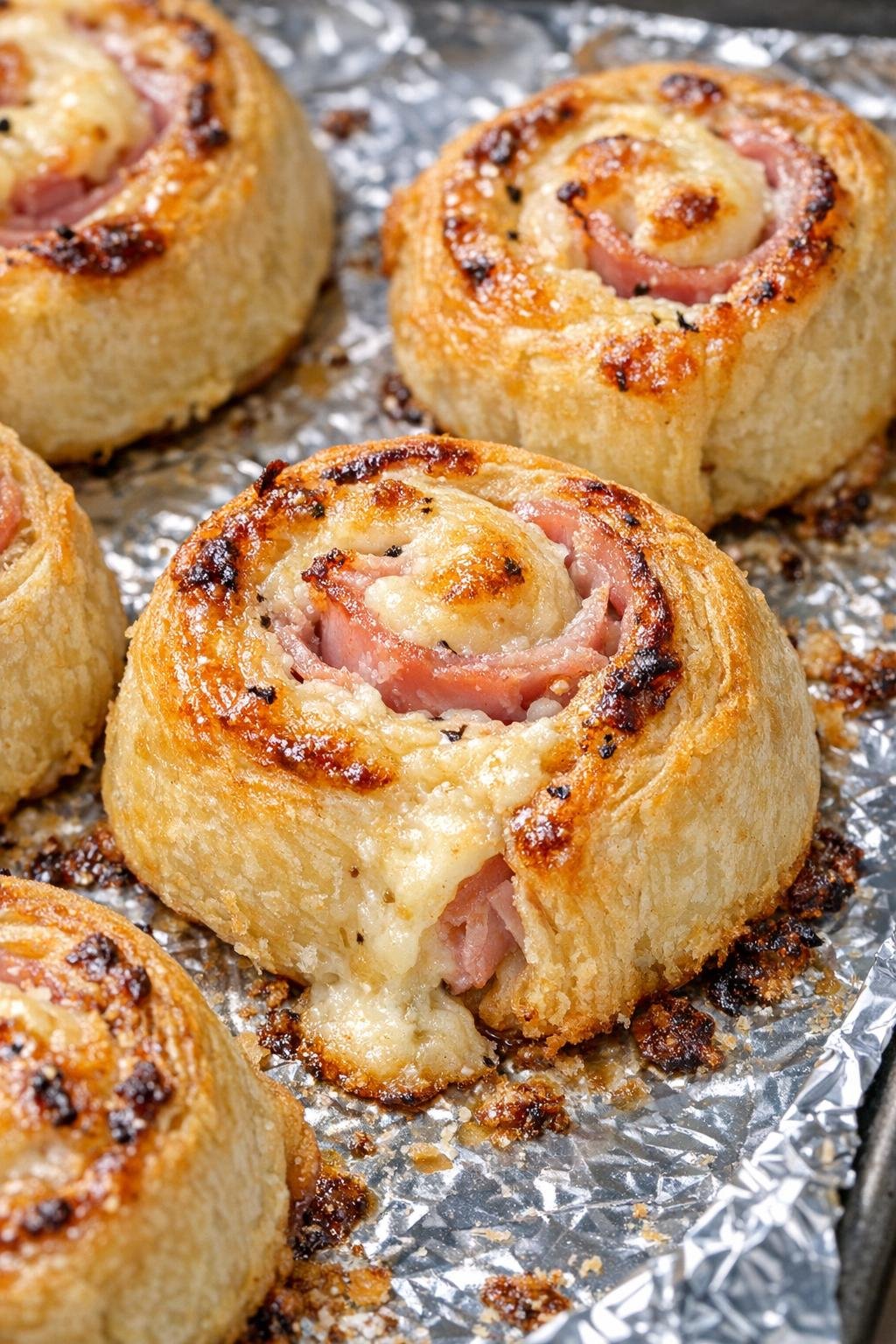 Southern 3-ingredient cream cheese pinwheels on a foil-lined baking tray