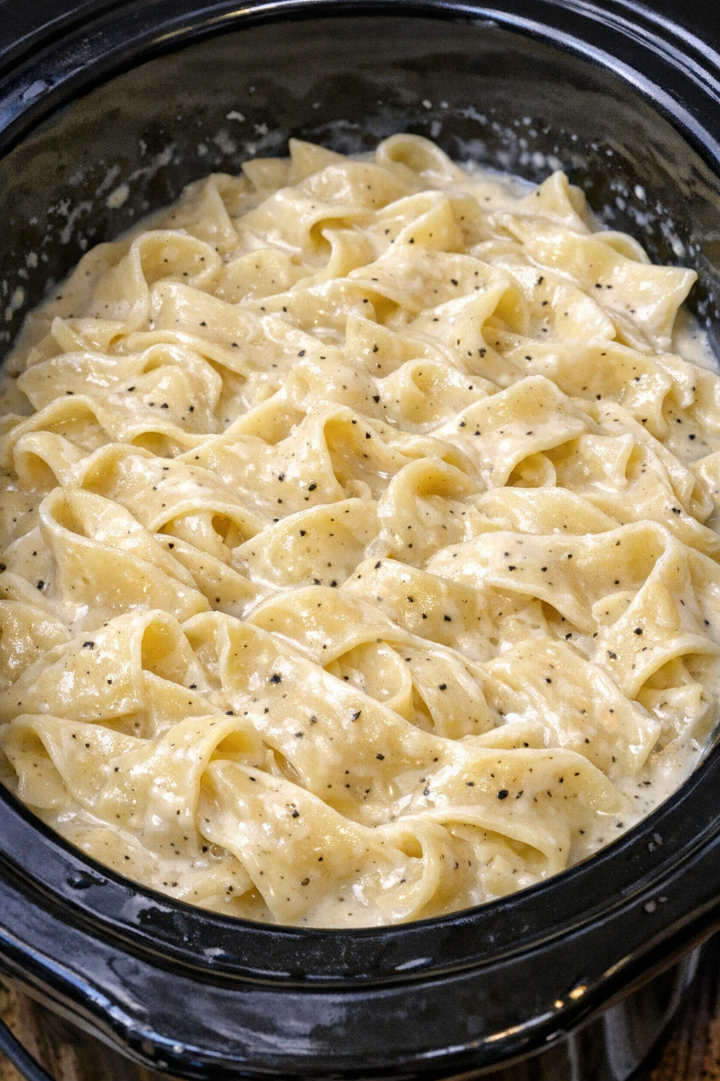 Slow cooker Amish heavy cream noodles in a black slow cooker