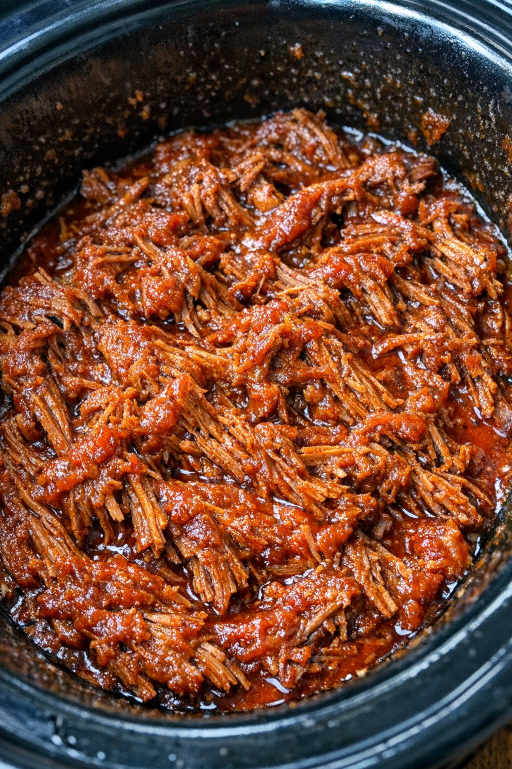Slow cooker shredded taco beef in a black slow cooker