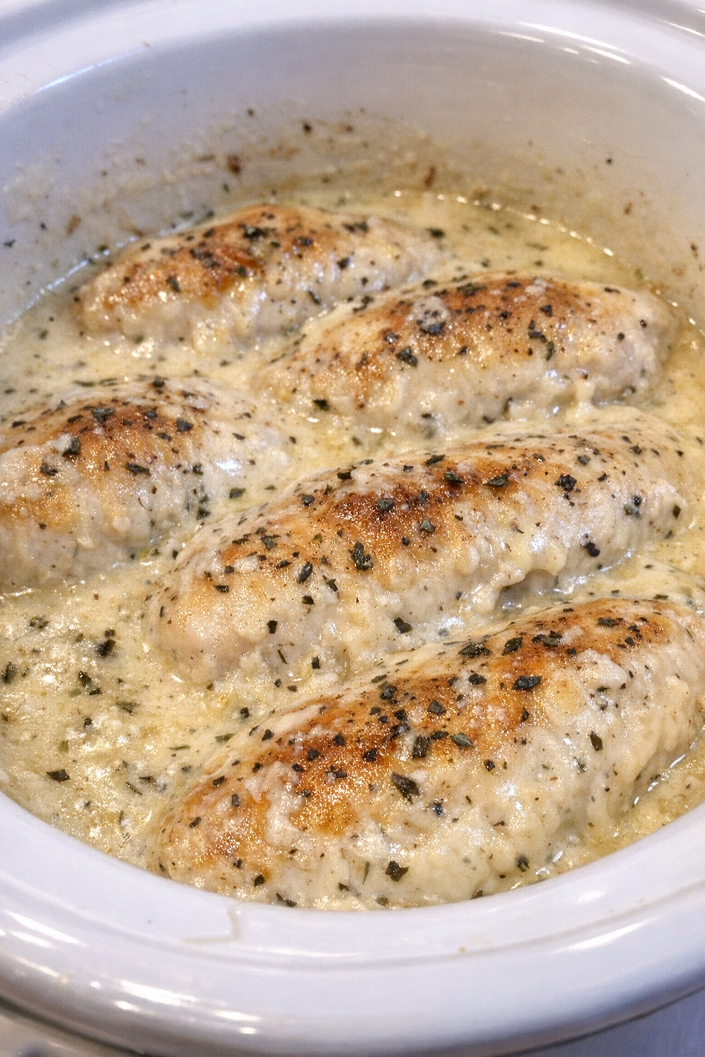 Slow cooker Amish farmhouse chicken in a white slow cooker