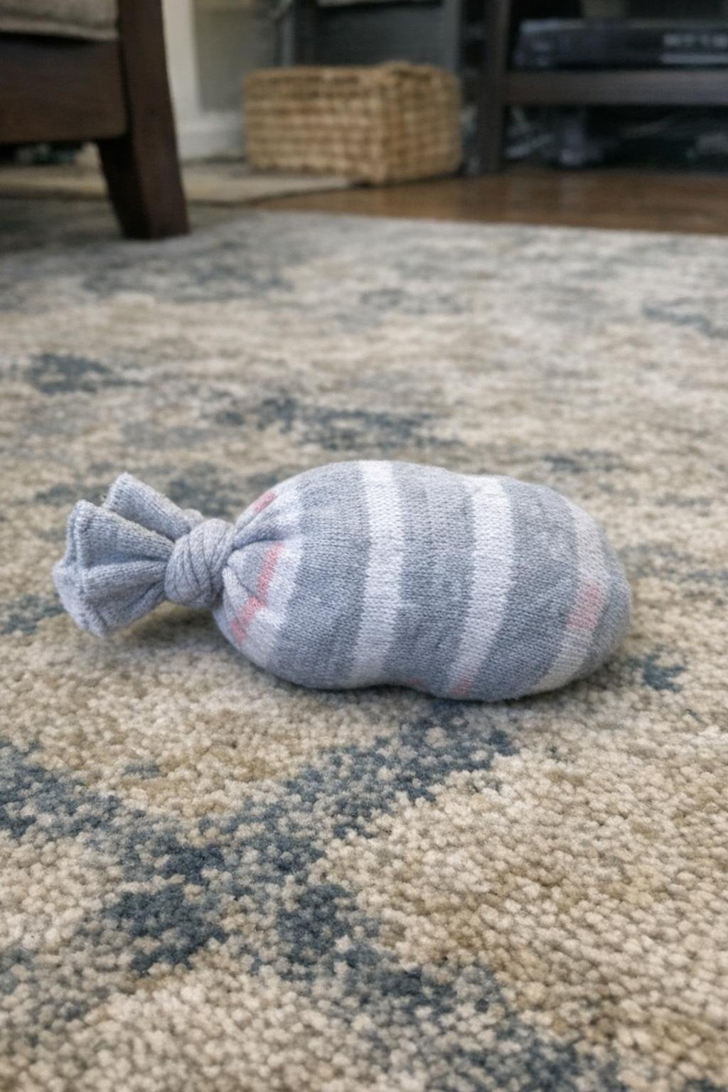 A knotted sock cat toy stuffed to make a crinkly shape
