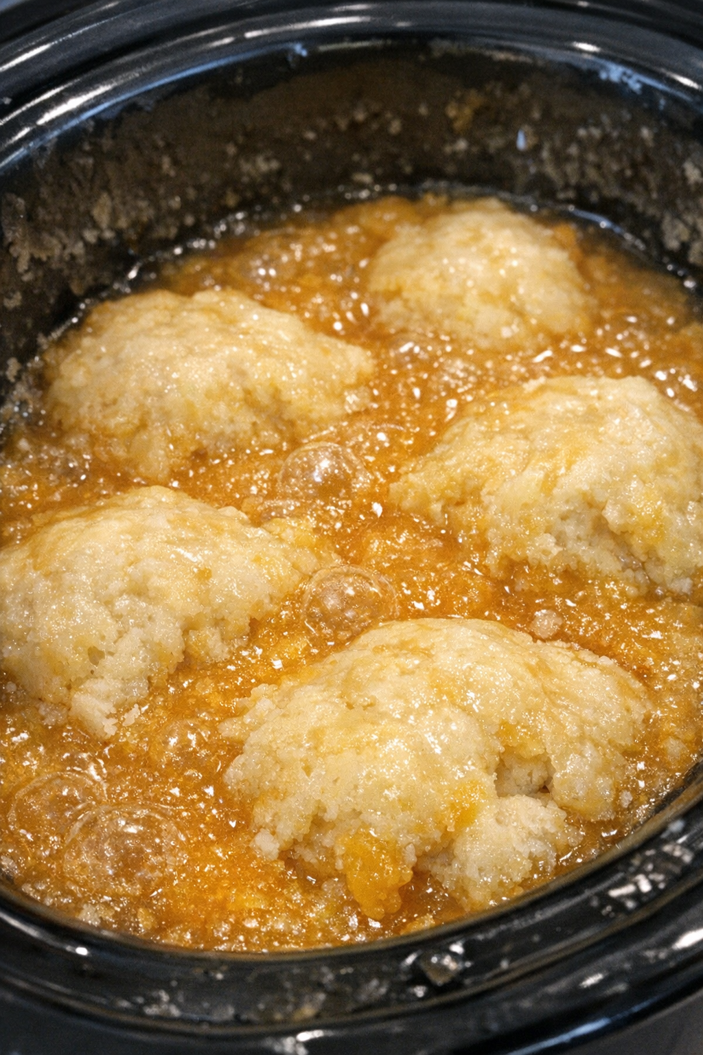 Bubbling marigold-hued dessert in a slow cooker