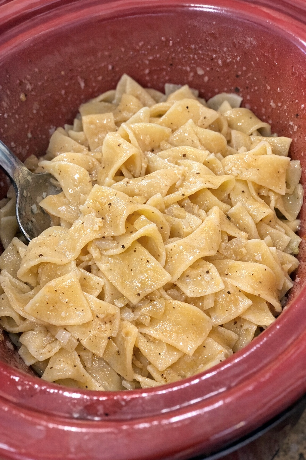 Slow cooker Amish vinegar noodles in a red slow cooker