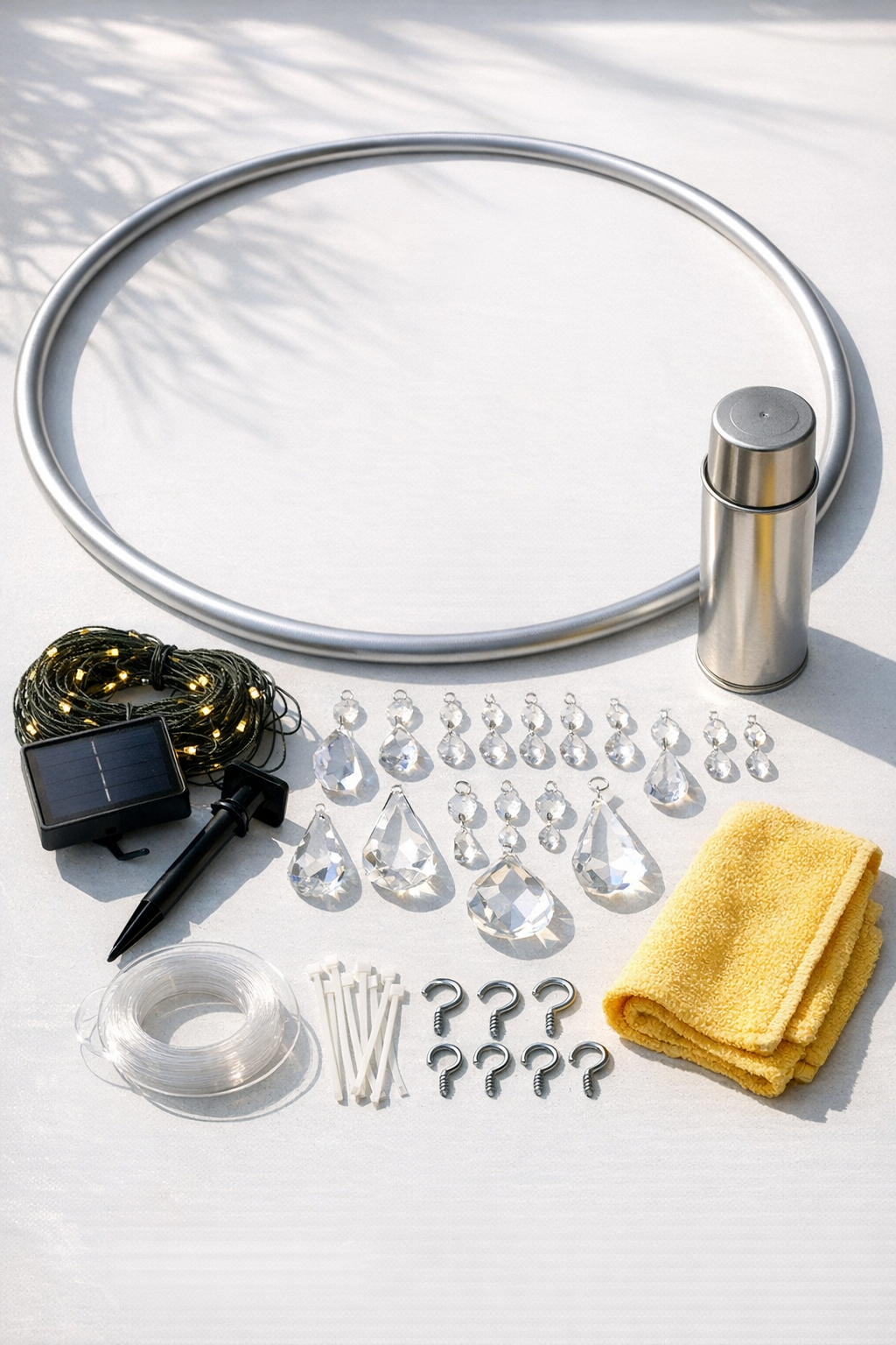 Materials for a solar hula hoop chandelier laid out on a work surface