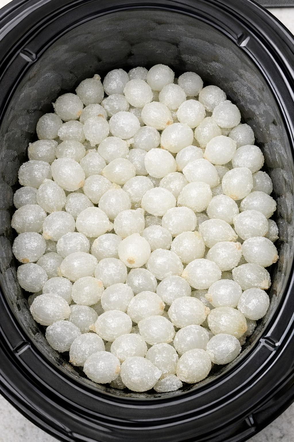 Frozen pearl onions layered in slow cooker