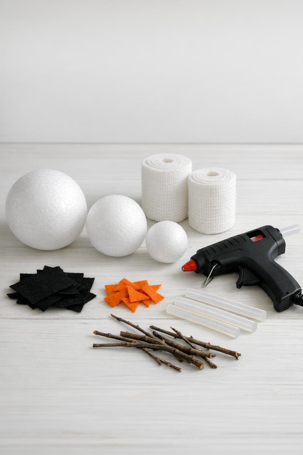 Materials for the gauze-wrapped foam ball winter craft laid out on a table