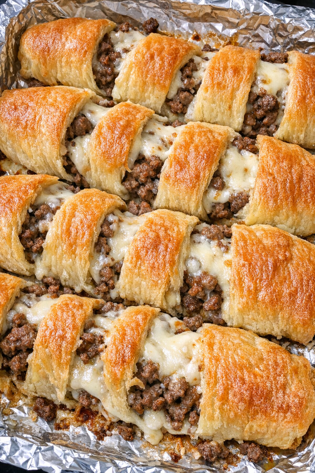 Finished beef crescent strips with golden pastry and melted provolone