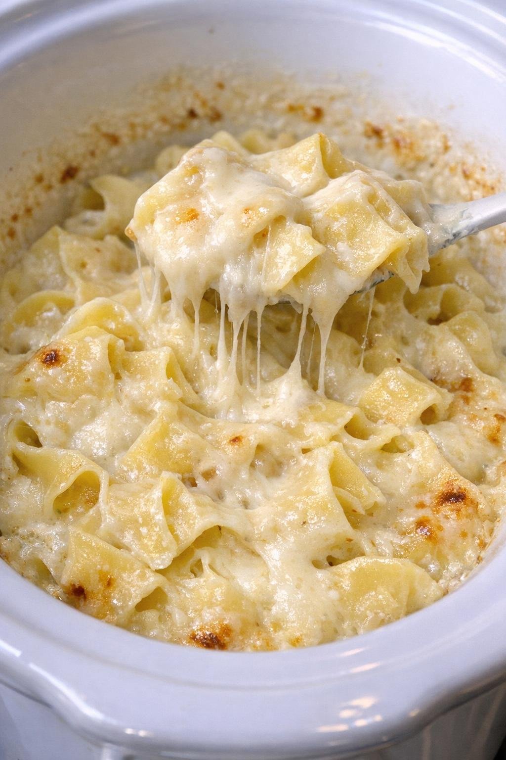 Finished Swiss cheese noodles in a white slow cooker