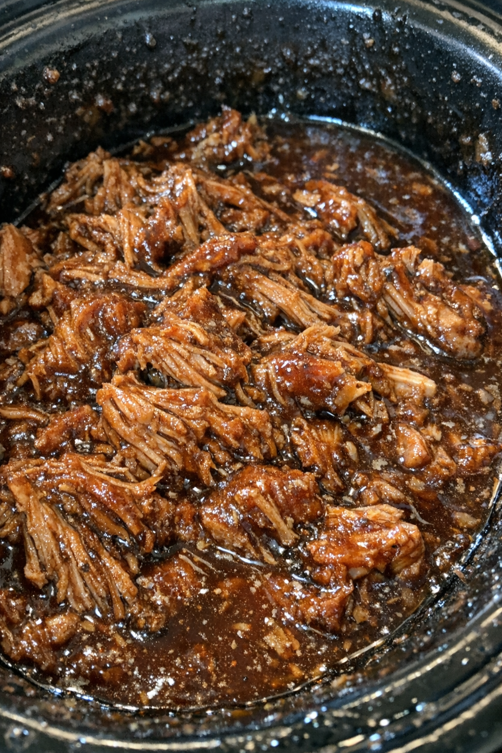 Slow cooker barbecue pulled pork in dark sauce