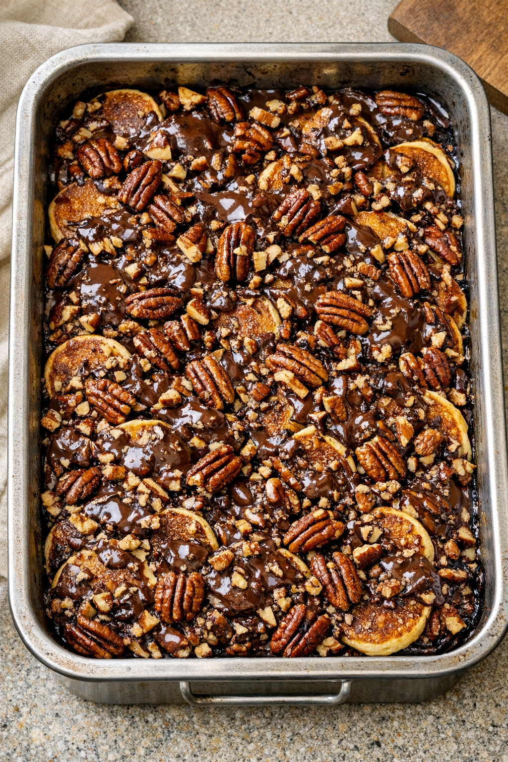 Baked chocolate pecan pancake dessert in a roasting pan