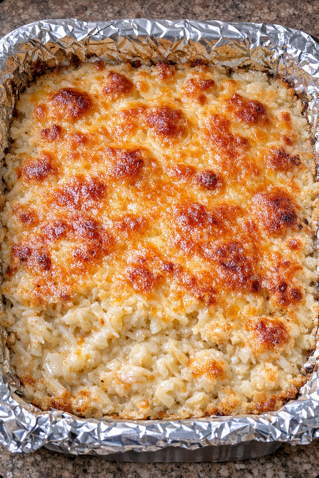 4-ingredient hashbrown casserole in a foil-lined baking dish
