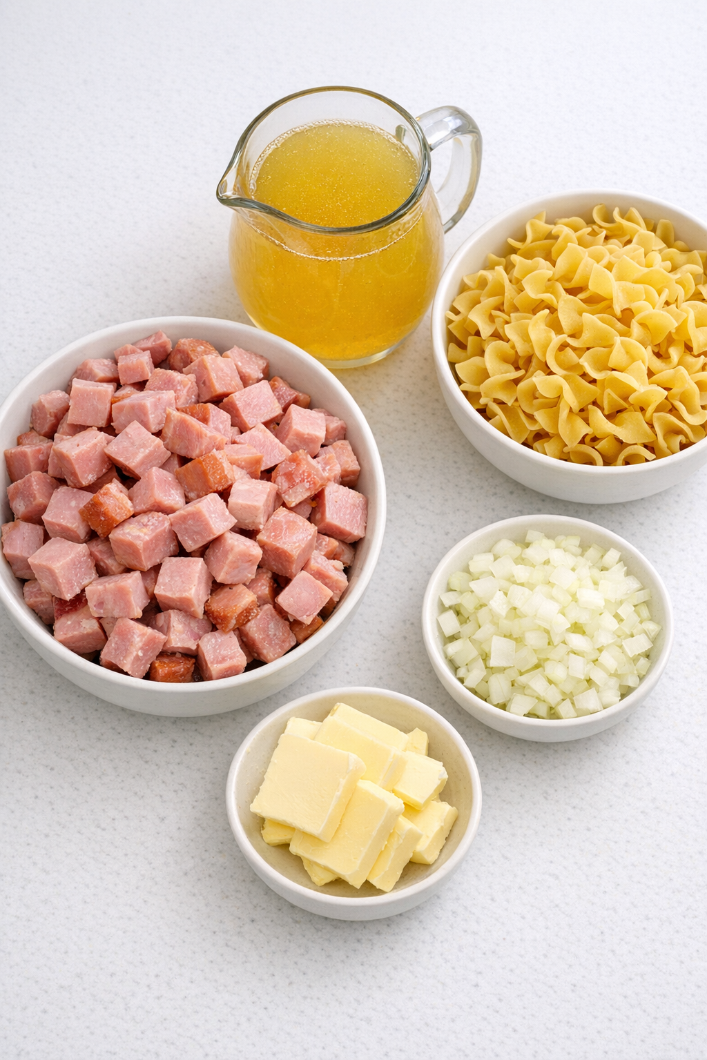 Measured ingredients for ham pasta on a kitchen counter