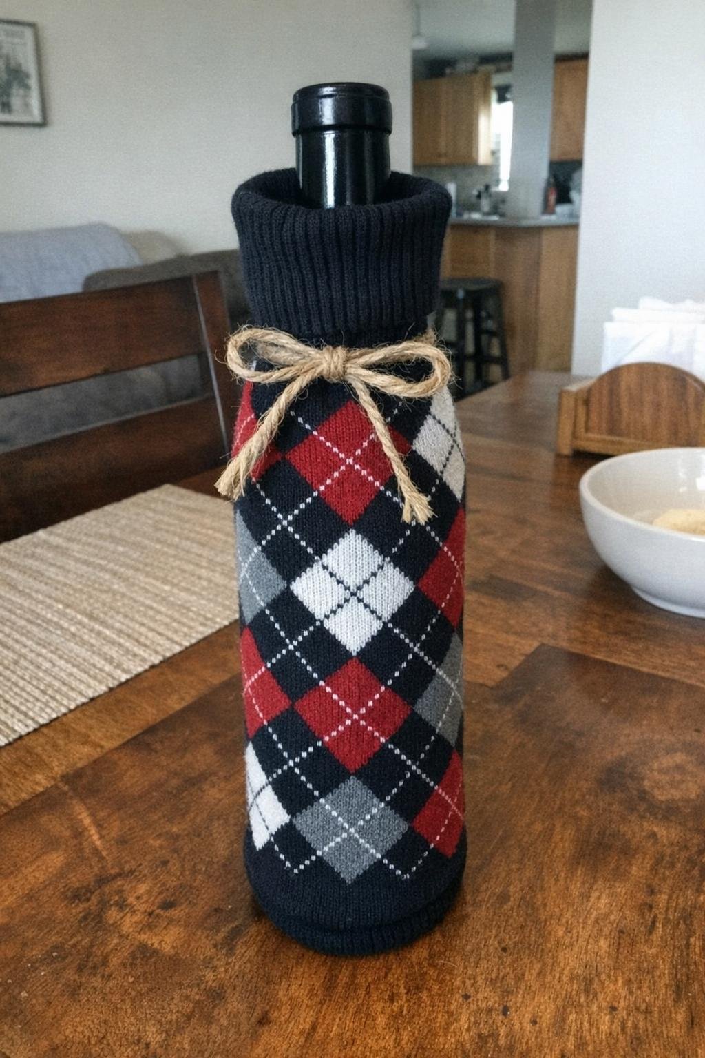 A wine bottle covered with an argyle sock and tied with twine