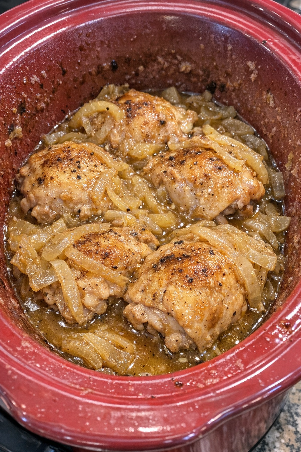 Slow cooker Amish sweet onion chicken in a red slow cooker