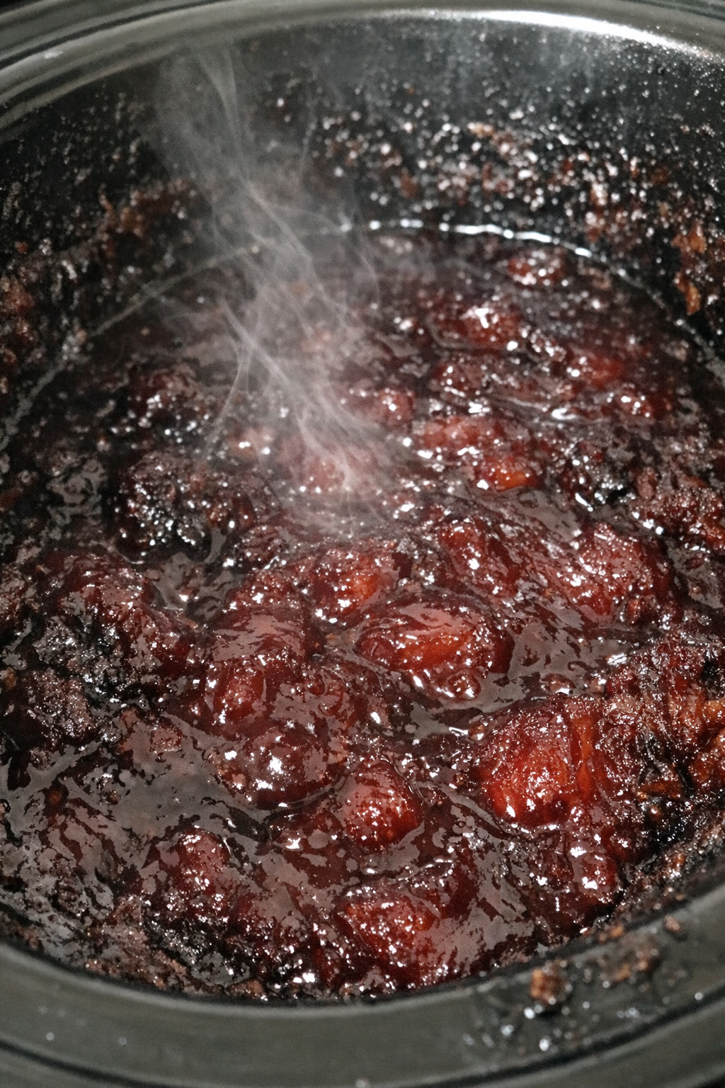 Dense dark-ruby slow cooker dessert in the cooker