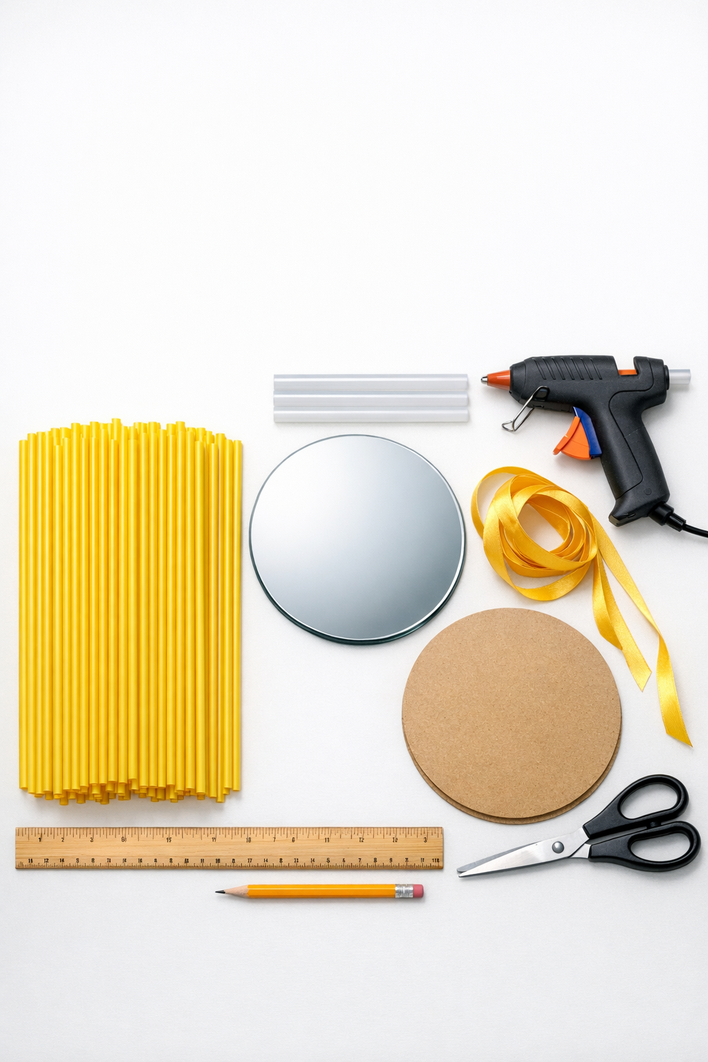 Materials for a straw sunburst door hanger laid out on a table