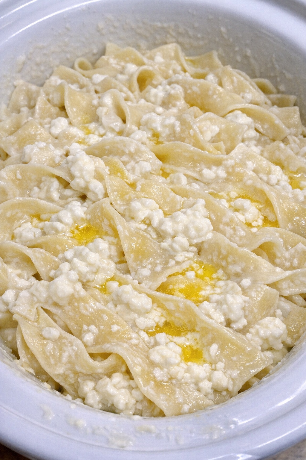Creamy Amish cottage cheese noodles in a white slow cooker