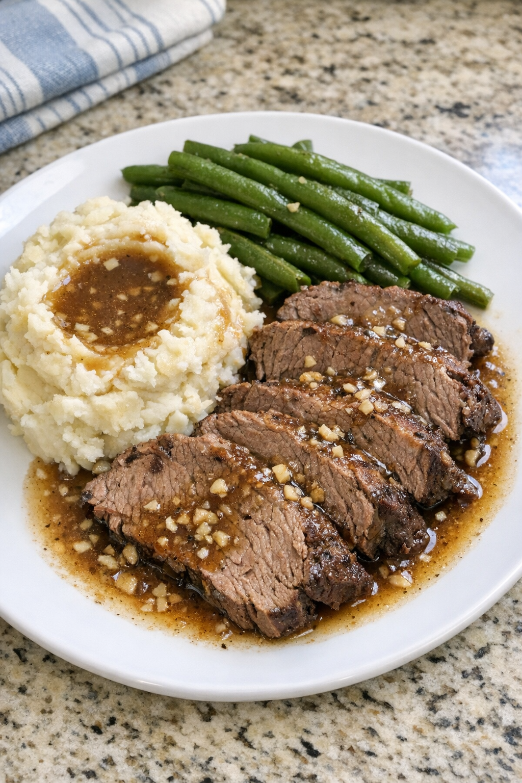 Finished Amish garlic beef roast plated with potatoes and green beans