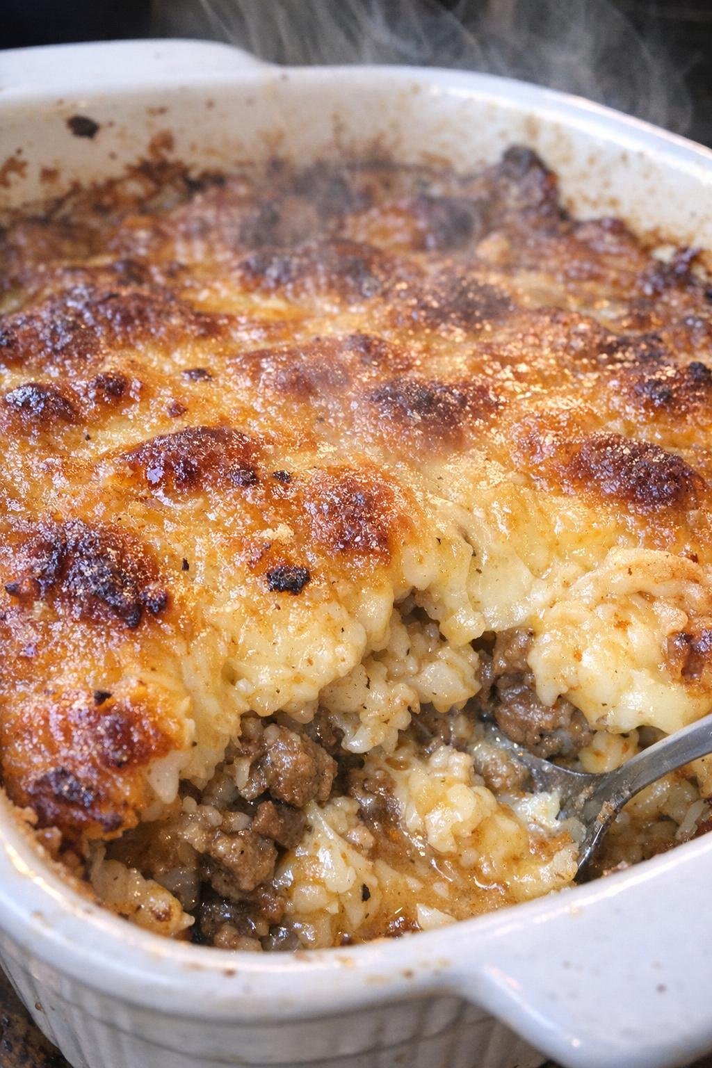 Bubbling golden baked casserole in a ceramic dish