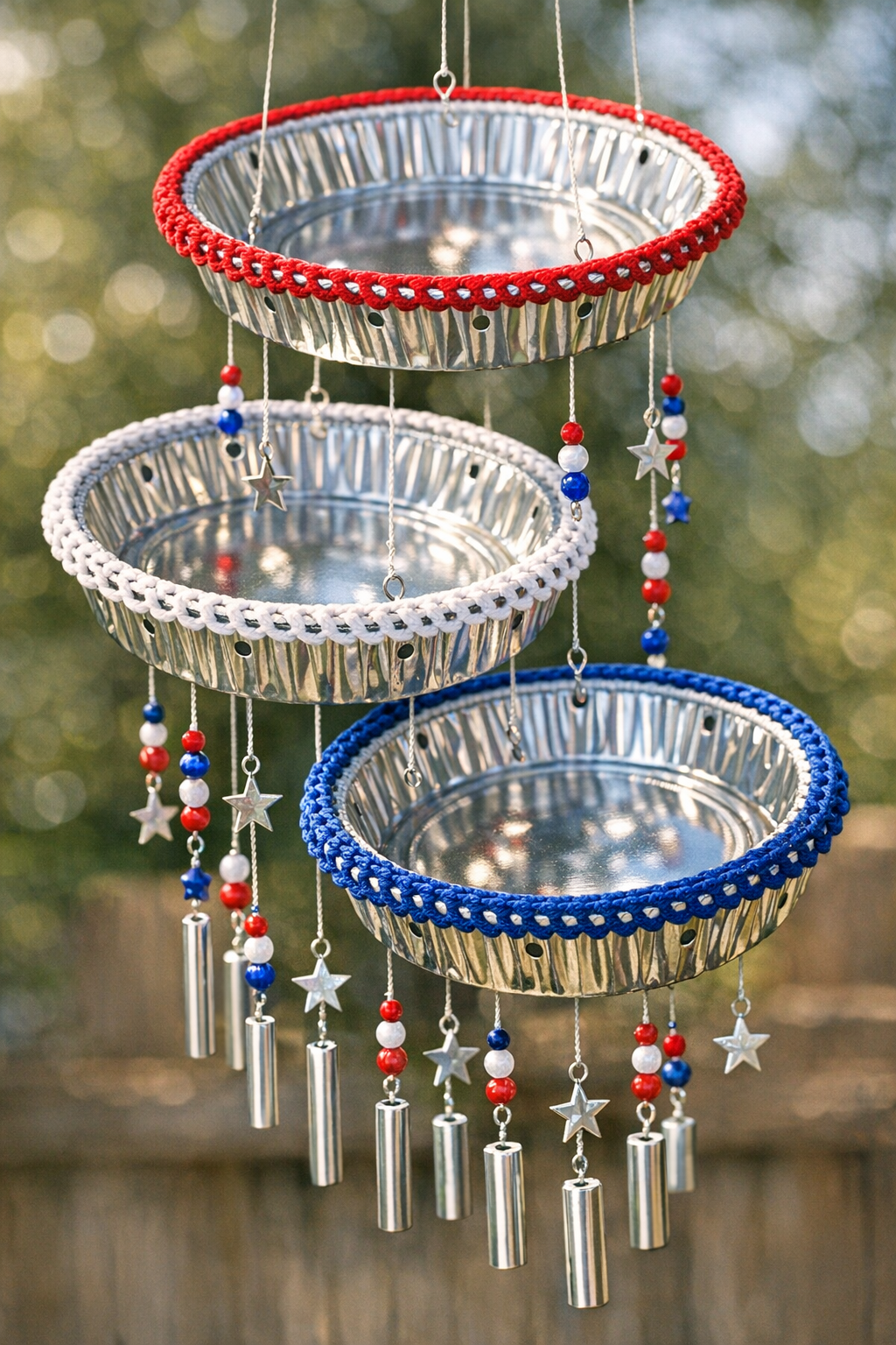 Finished patriotic crochet pie tin wind chime hanging outdoors