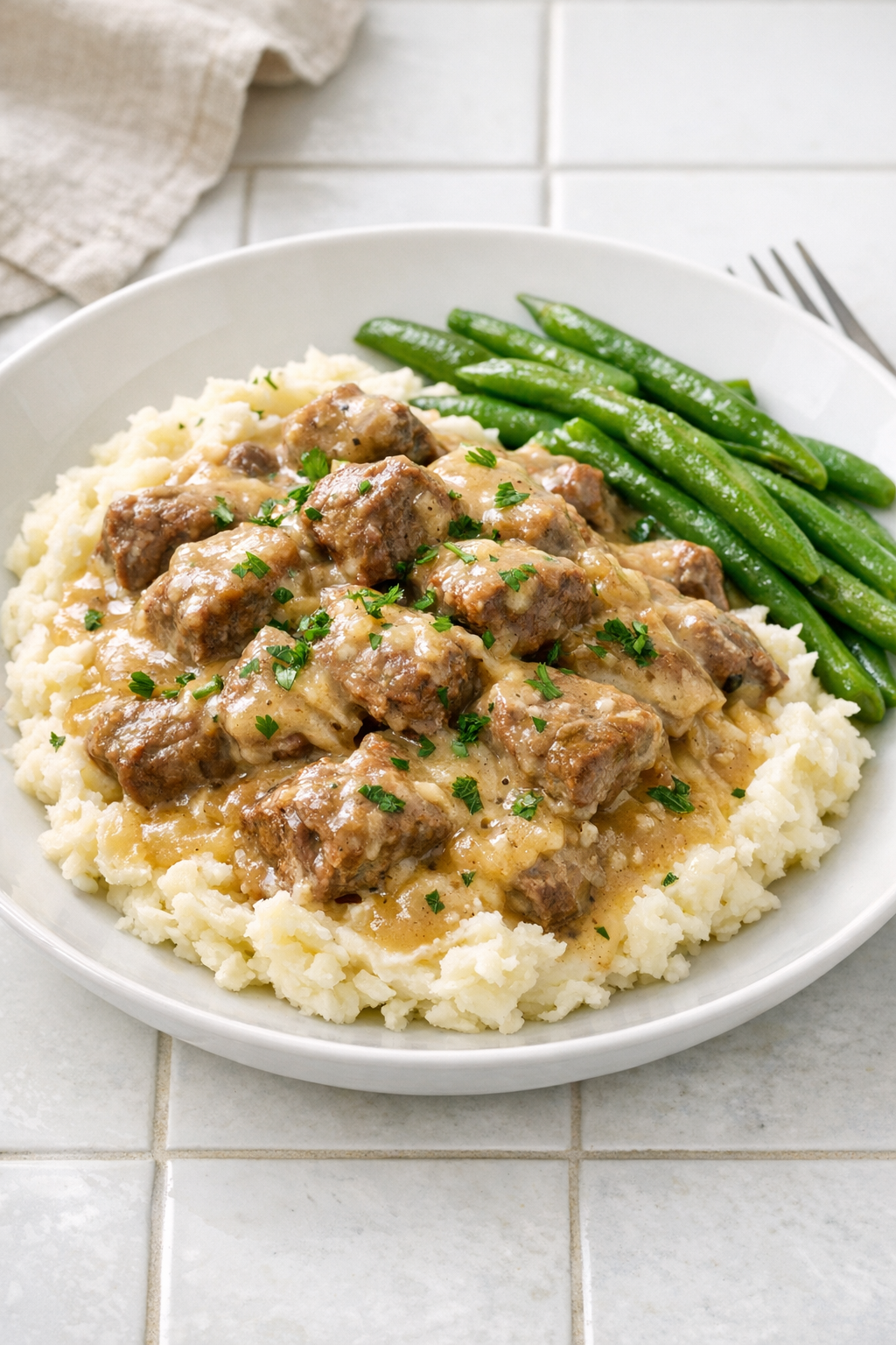Finished slow cooker French onion beef plated with creamy sides