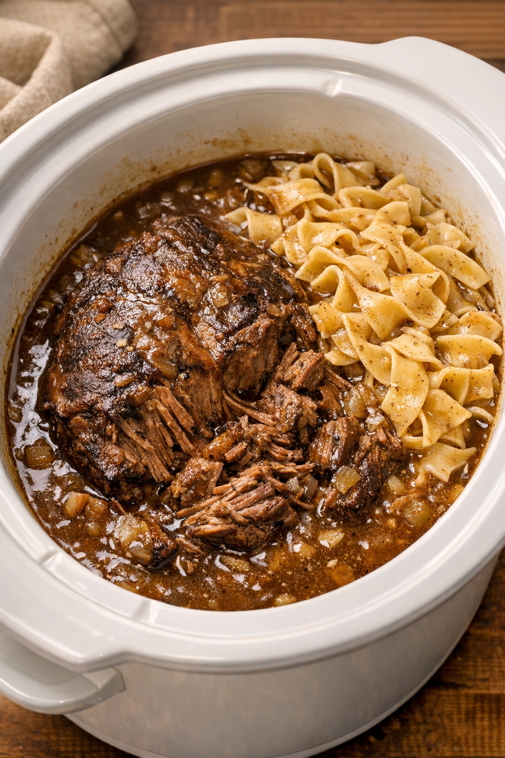 Tender cooked beef in rich gravy in the slow cooker
