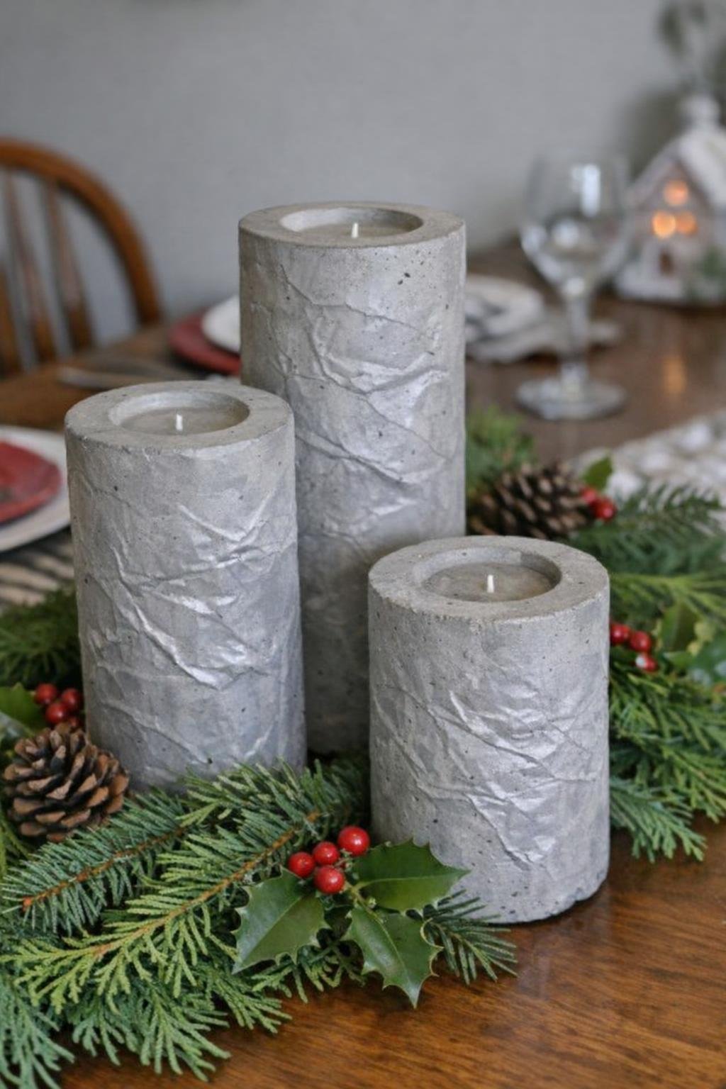 Concrete candle pillars in graduated heights on a table