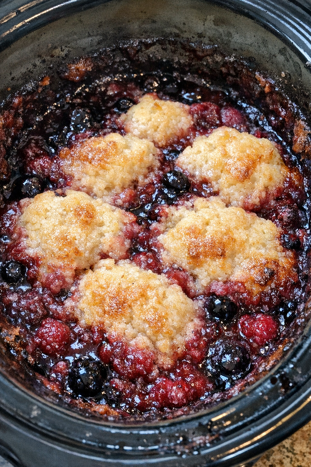 Finished slow cooker berry bake with golden topping