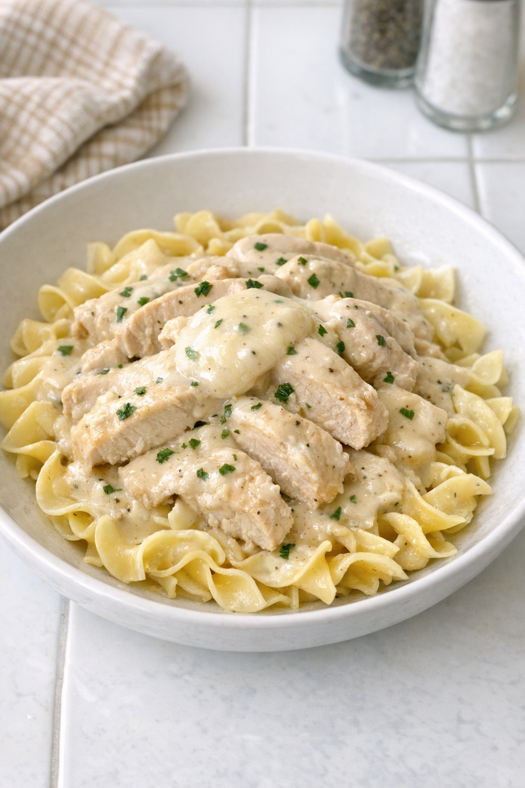 Creamy Amish sour cream chicken pasta plated in a bowl