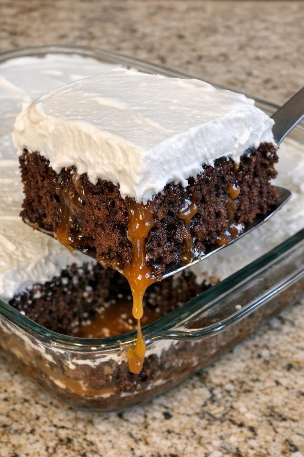 Chocolate sheet cake with caramel and whipped topping in glass dish