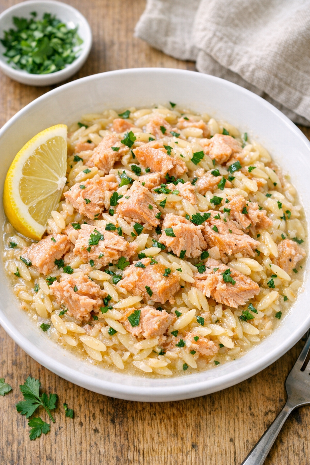 Baked salmon orzo served in a shallow bowl
