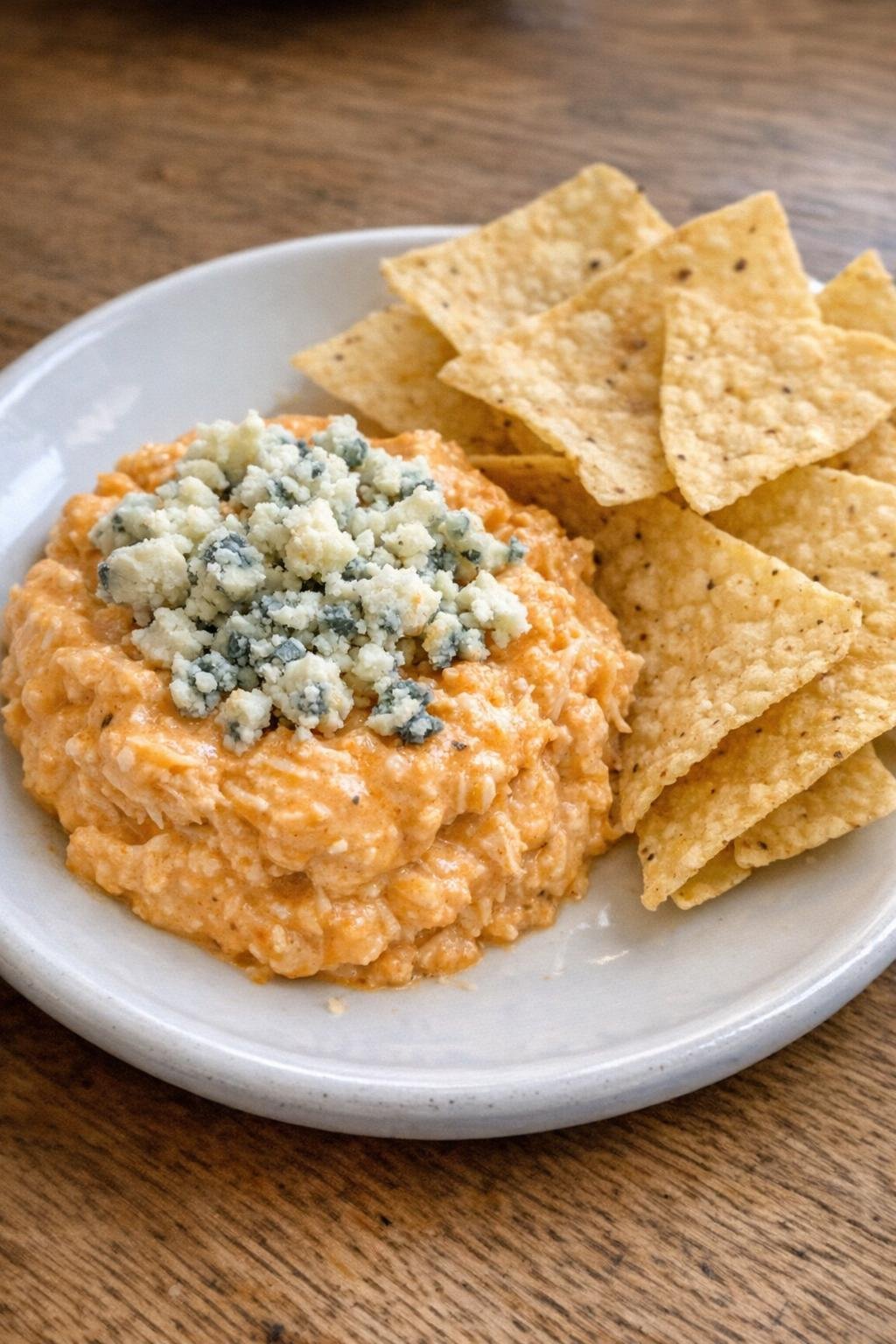 Single serving of slow cooker buffalo chicken dip with tortilla chips