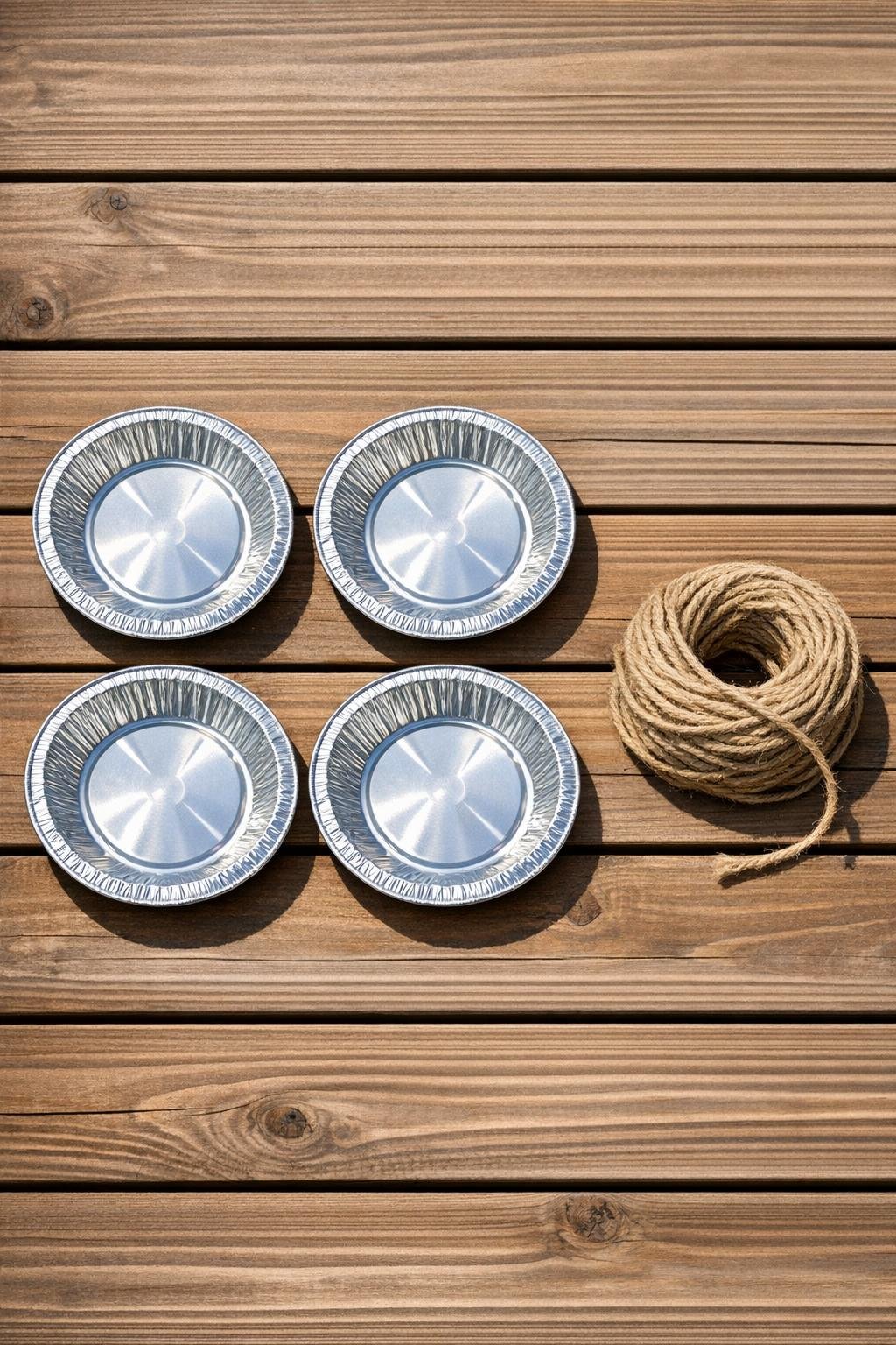 Aluminum pie tins and garden twine laid out as materials