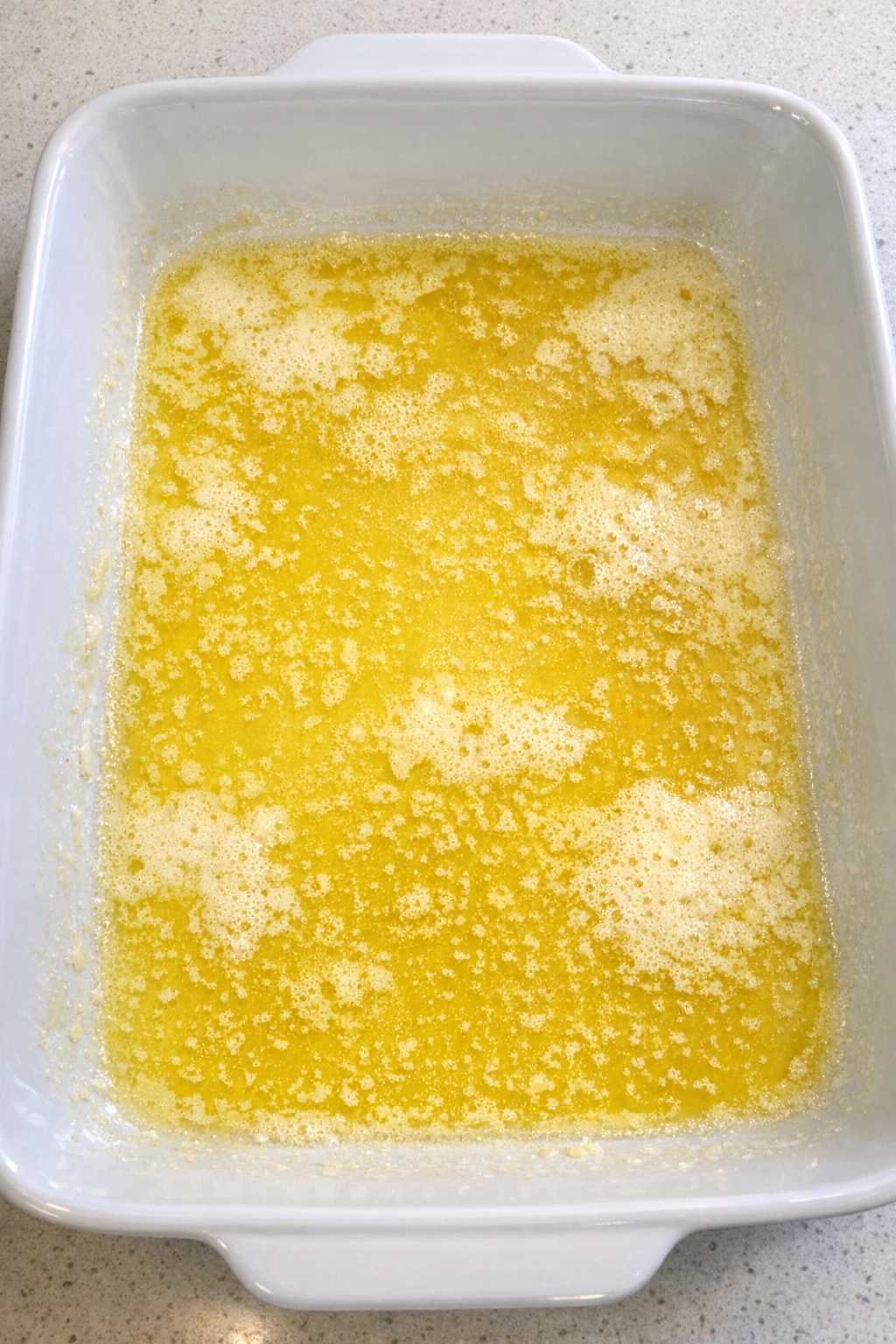 Melted butter in casserole dish