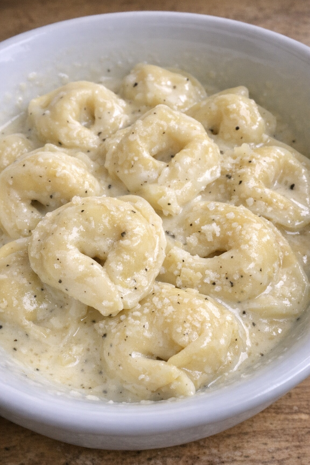 Creamy garlic parmesan tortellini in a white bowl