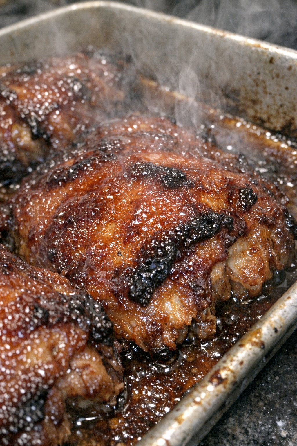 Roasted glazed protein in a metal baking sheet