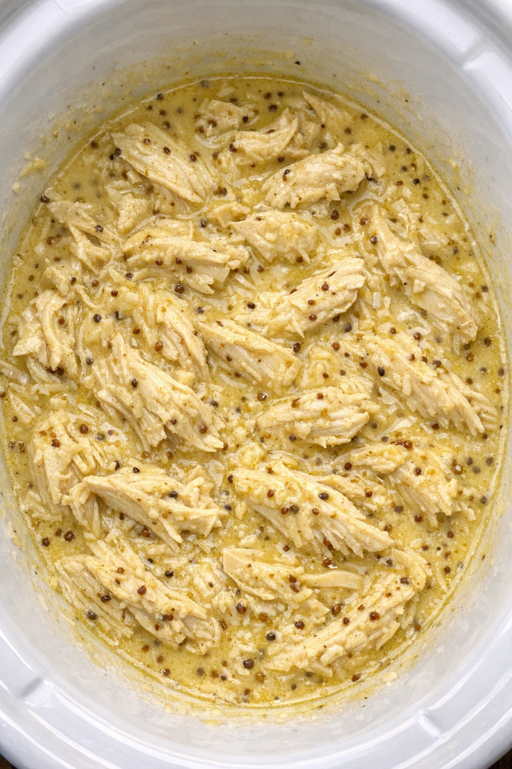 Slow cooker creamy honey mustard chicken in a white slow cooker
