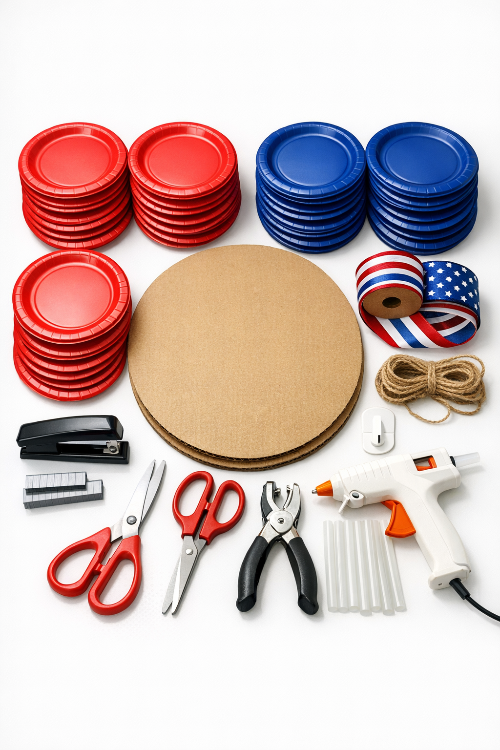 Paper plates, pizza box, ribbon, stapler, and hanging supplies laid out for the project