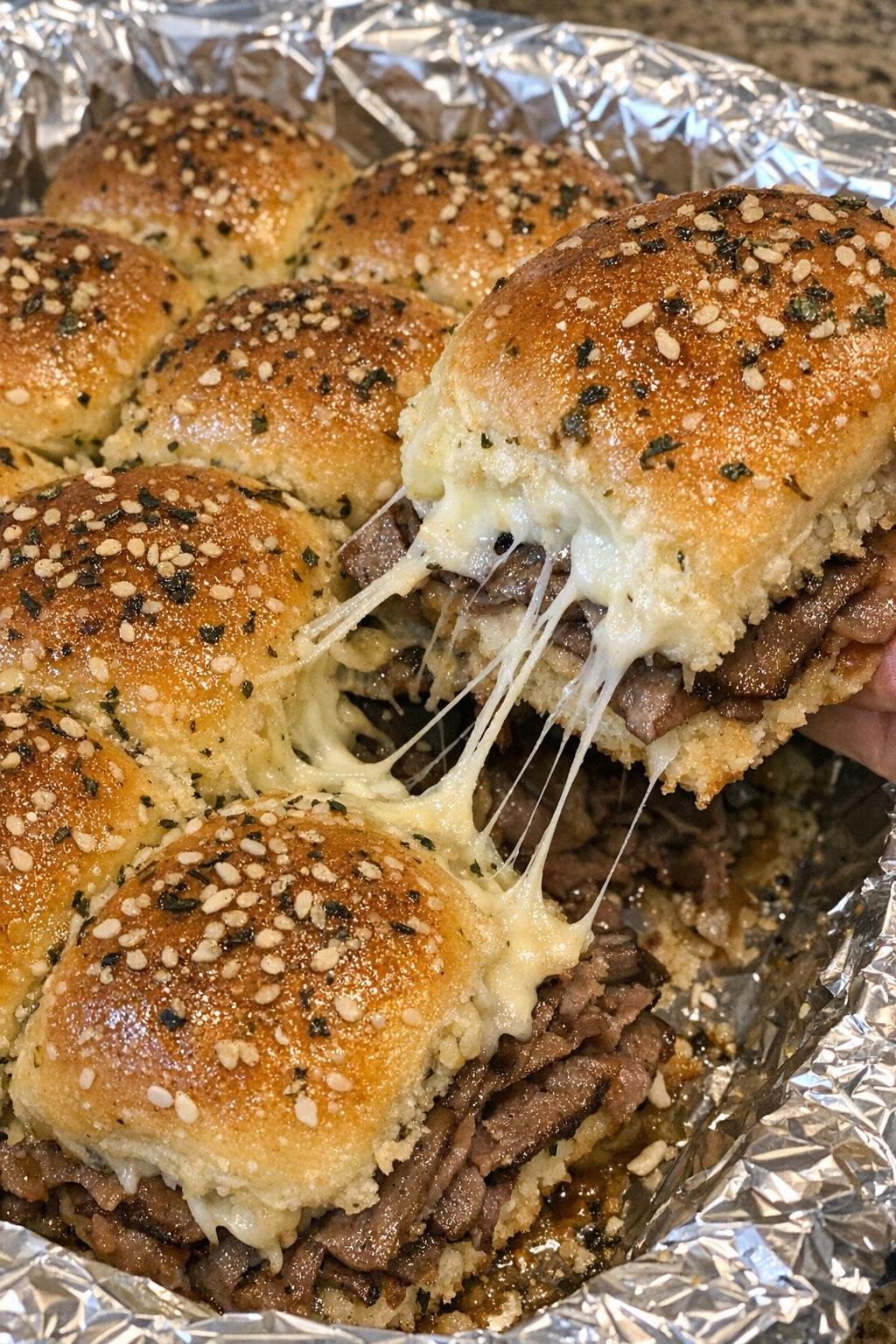 French dip sliders in a foil-lined platter