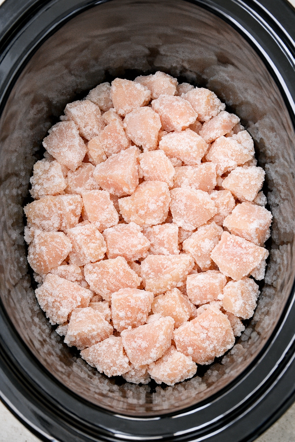 Frozen chicken arranged in the slow cooker