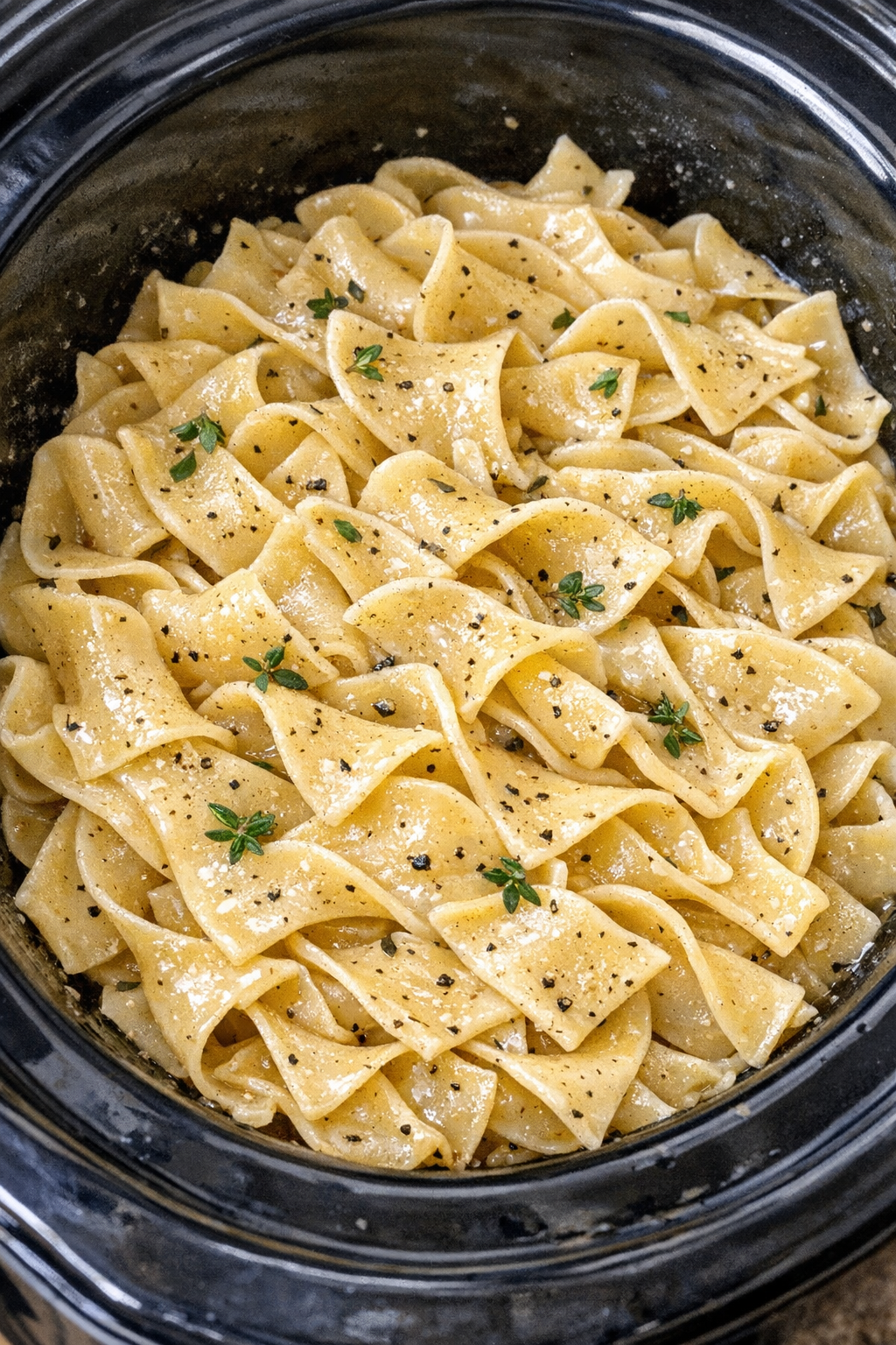 Slow cooker Amish thyme noodles in a black slow cooker