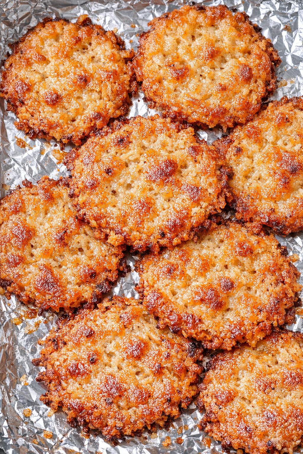 Low carb 3-ingredient parmesan chicken crisps on a foil-lined baking tray