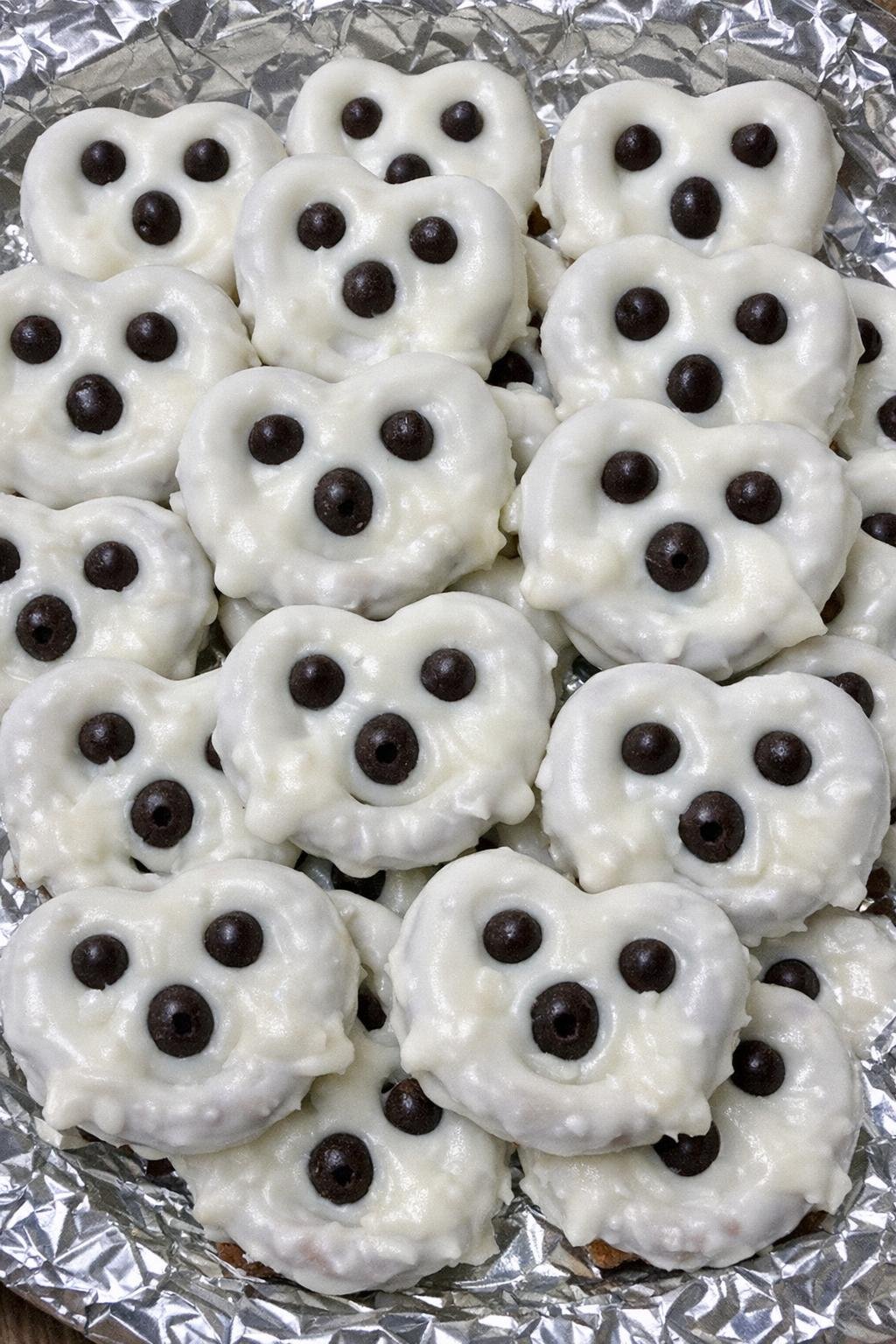 Ghost pretzels on a foil-lined serving platter