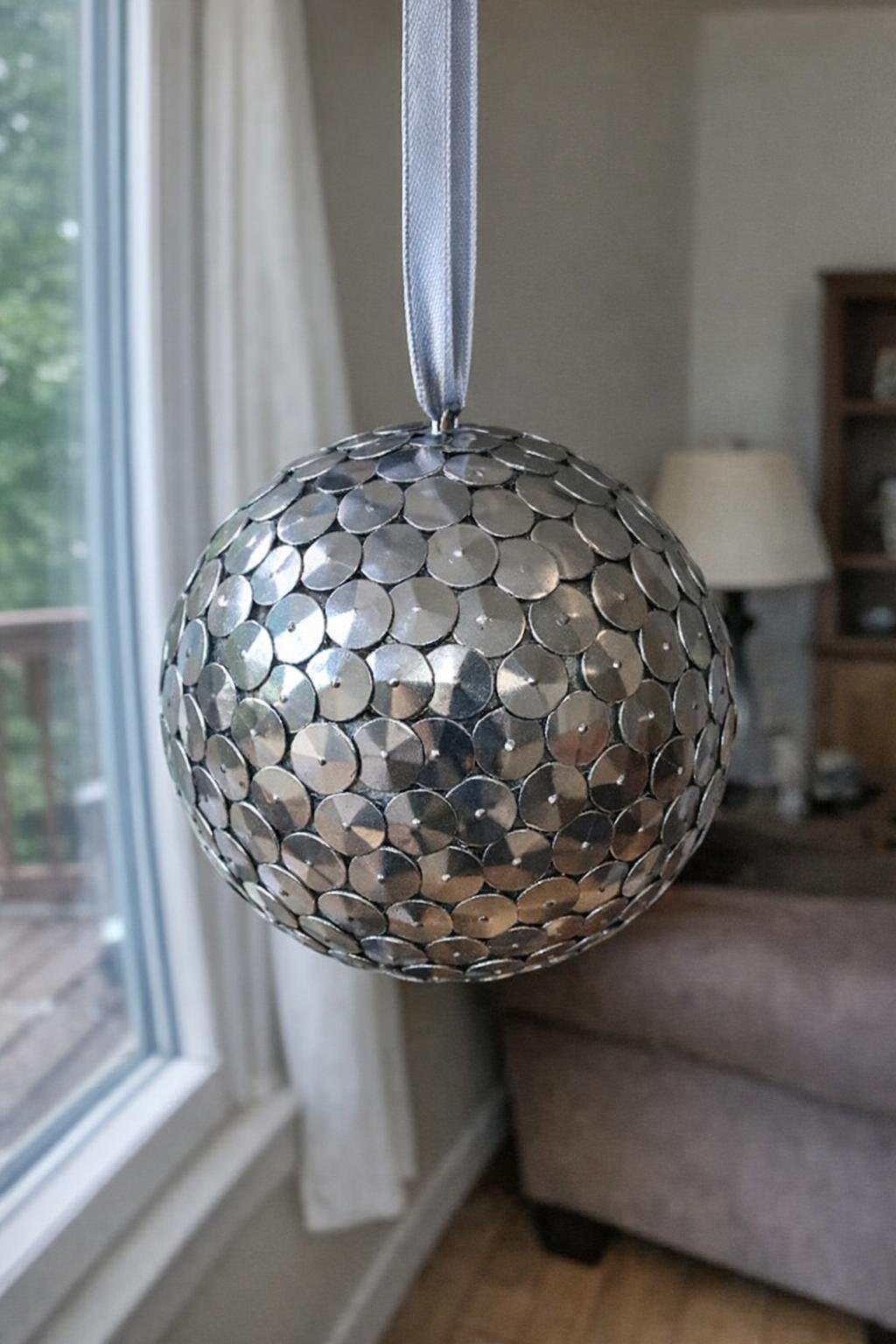 Thumbtack disco ball hanging on ribbon