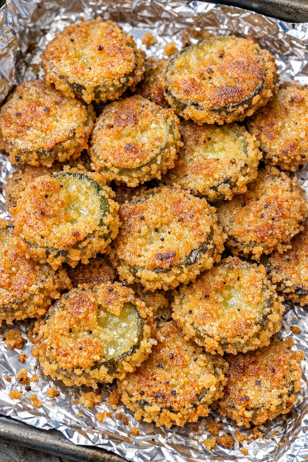 Southern 4-ingredient crispy fried pickles on a foil-lined baking tray