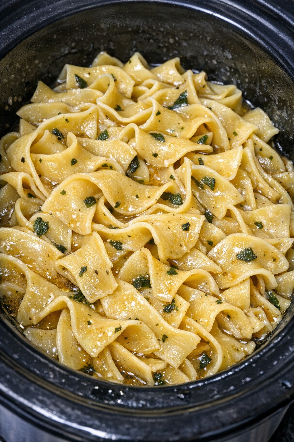 Slow cooker Amish sage butter noodles in a black slow cooker